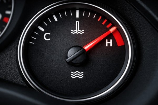 Engine temperature gauge showing needle in danger zone indicating car cooling system failure